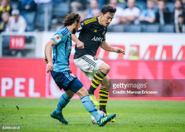 Kevin Walker of Djurgardens IF chasing Stefan Ishizaki of AIK during the Allsvenskan match between AIK and Djurgardens IF at Friends arena on August...