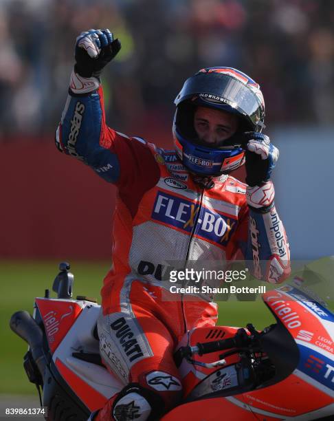Andrea Dovizioso of Italy and Ducati Team celebates after winning the MotoGP of Great Britain at Silverstone Circuit on August 27, 2017 in...