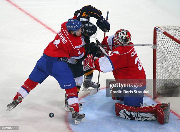 Goaltender Ari Sulander and Patrick Geering of ZSC Lions Zurich battle for the puck with Petri Lammassaari of Espoo Blues during the IIHF Champions...