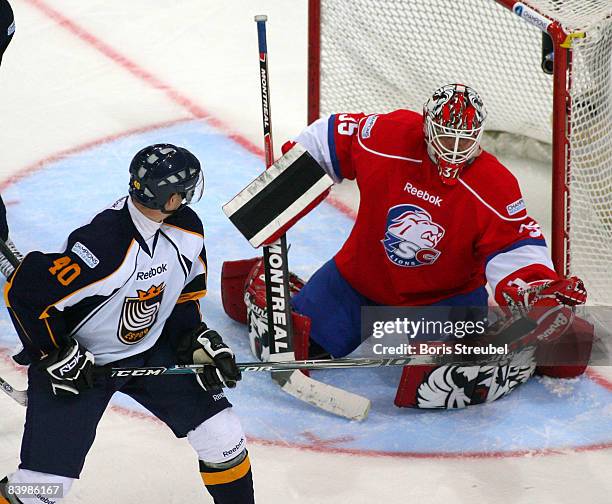 Goaltender Ari Sulander of ZSC Lions Zurich battles for the puck with Jaakko Uhlback of Espoo Blues during the IIHF Champions Hockey League...