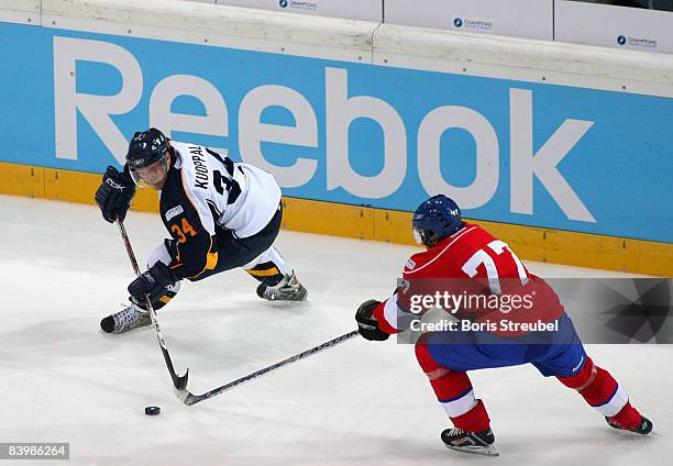 Adrian Wichser of ZSC Lions Zurich battles for the puck with Ismo Kuoppala of Espoo Blues during the IIHF Champions Hockey League semi-final match...