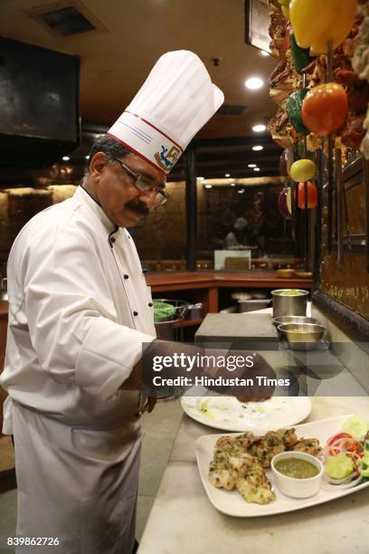 Chef JP Singh, Executive Chef, Bukhara, ITC Maurya, prepares 'Murgh Mirch Malai Tikka' during the Day 1 of HT City's Culinary Fest, Season III, at...