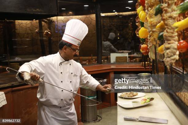 Chef JP Singh, Executive Chef, Bukhara, ITC Maurya, prepares 'Murgh Mirch Malai Tikka' during the Day 1 of HT City's Culinary Fest, Season III, at...