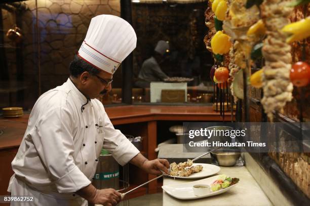 Chef JP Singh, Executive Chef, Bukhara, ITC Maurya, prepares 'Murgh Mirch Malai Tikka' during the Day 1 of HT City's Culinary Fest, Season III, at...