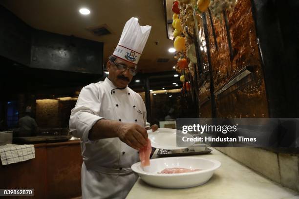 Chef JP Singh, Executive Chef, Bukhara, ITC Maurya, prepares 'Murgh Mirch Malai Tikka' during the Day 1 of HT City's Culinary Fest, Season III, at...