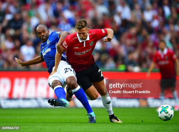 Naldo of Schalke 04 is challenged by Niclas Fuellkrug of Hannover 96 during the Bundesliga match between Hannover 96 and FC Schalke 04 at HDI-Arena...