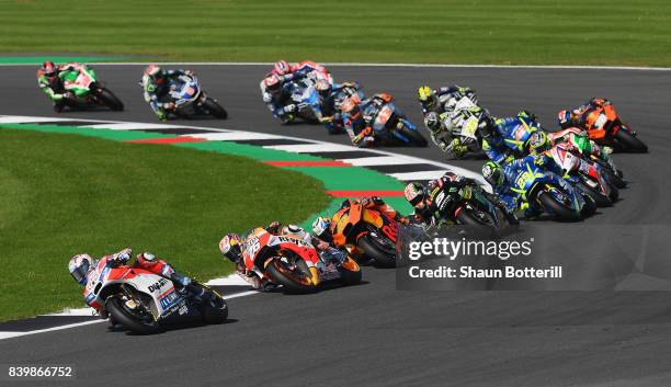 Andrea Dovizioso of Italy and Ducati Team on the first lap during the MotoGP of Great Britain at Silverstone Circuit on August 27, 2017 in...