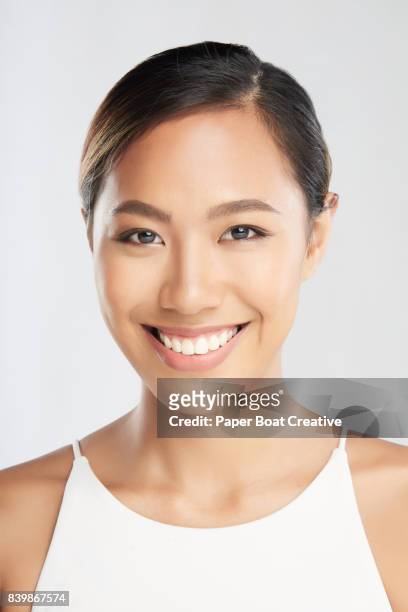 beautiful east asian woman smiling about living a healthy life with good beauty routine - beautiful filipino women stock pictures, royalty-free photos & images
