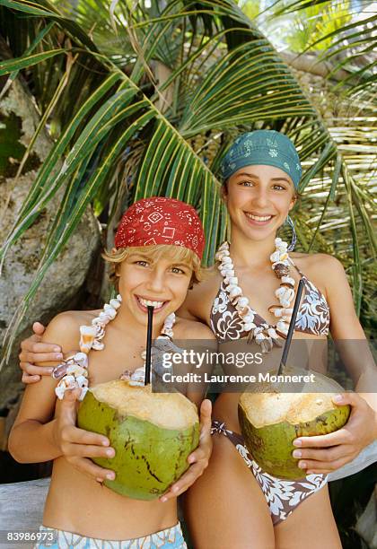 young boy and girl drinking fresh coconut milk - doce coco fotografías e imágenes de stock