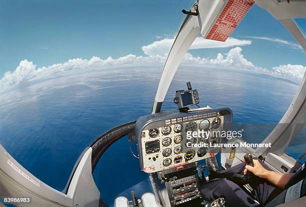 cockpit of an helicopter flying over ocean - fregate stock pictures, royalty-free photos & images