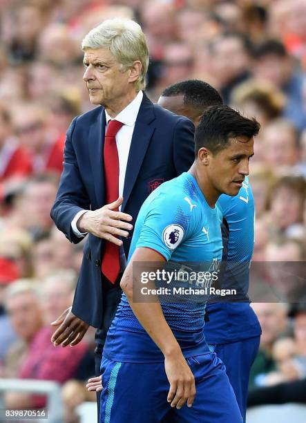 Alexis Sanchez of Arsenal and Arsene Wenger, Manager of Arsenal embrace after he is subbed during the Premier League match between Liverpool and...