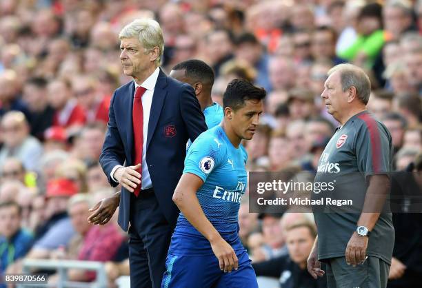 Alexis Sanchez of Arsenal and Arsene Wenger, Manager of Arsenal embrace after he is subbed during the Premier League match between Liverpool and...