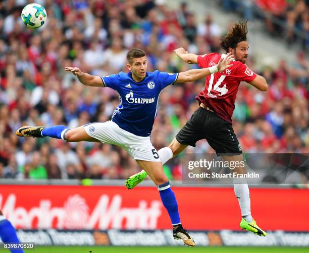 Matija Nastasic of Schalke 04 challenges Martin Harnik of Hannover 96 during the Bundesliga match between Hannover 96 and FC Schalke 04 at HDI-Arena...