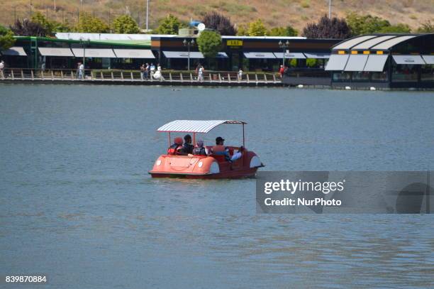 People ride a boat as they enjoy 10-day holiday for Muslims' traditional festival Eid al-Adha at the Goksu Park in Ankara, Turkey on August 27, 2017.