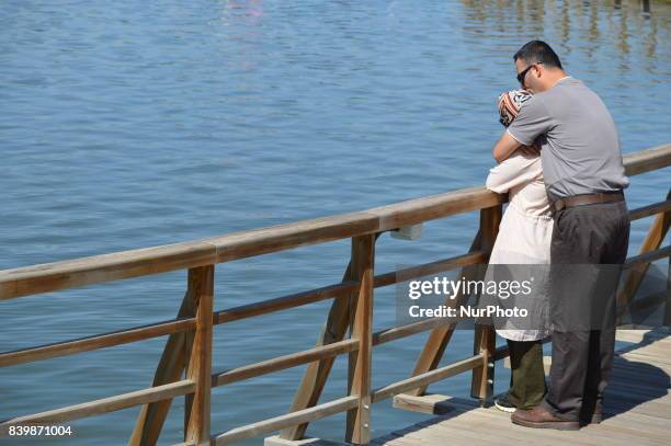 Couple can be seen on a pier as people enjoy 10-day holiday for Muslims' traditional festival Eid al-Adha at the Goksu Park in Ankara, Turkey on...