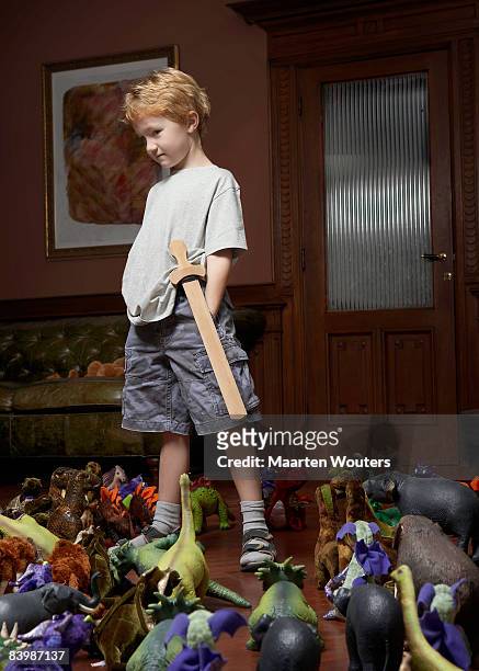 boy standing in a middle of a crowd of toys - one person in crowd stock pictures, royalty-free photos & images