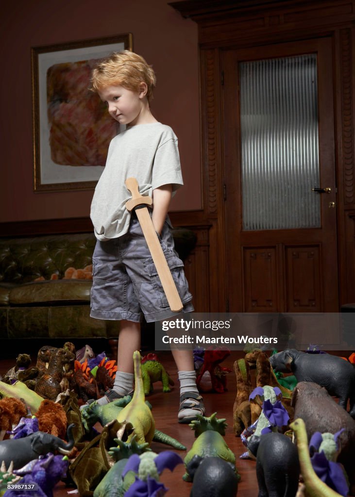 Boy standing in a middle of a crowd of toys