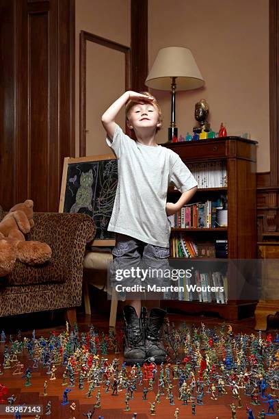 boy with his toy soldiers, giving a salute - kids proud stock pictures, royalty-free photos & images