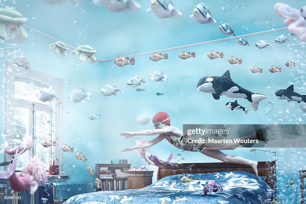 Girl swimming in her bedroom