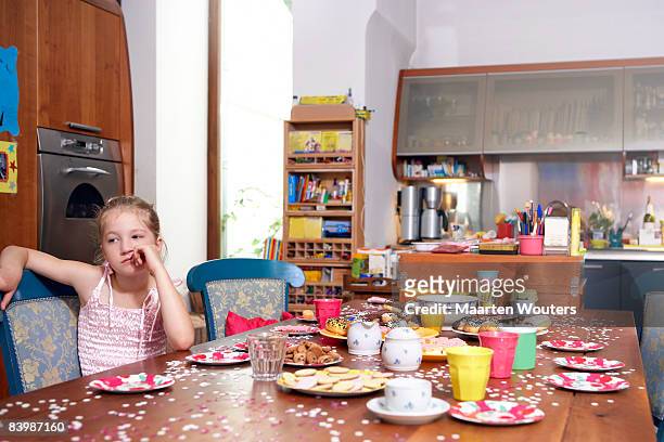 birthday girl waiting by the kitchen table - sad birthday foto e immagini stock