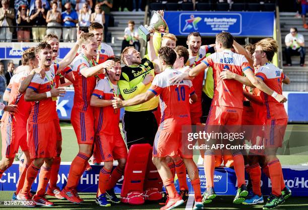 Players of The Netherlands celebrate after winning the men's final match between The Netherlands and Belgium at The European Hockey Championship in...