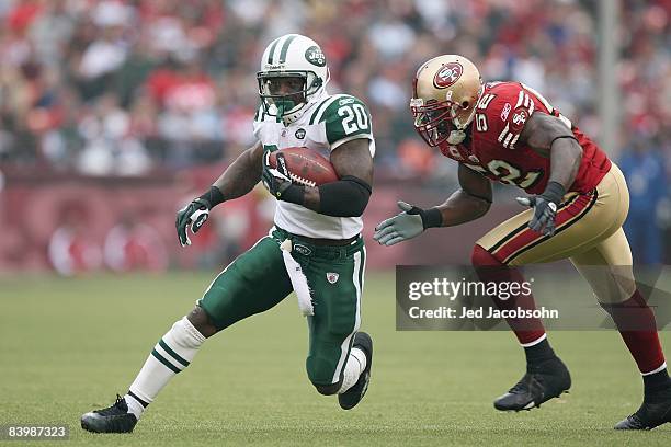 Thomas Jones of the New York Jets carries the ball against Patrick Willis of the San Francisco 49ers during an NFL game on December 7, 2008 at...