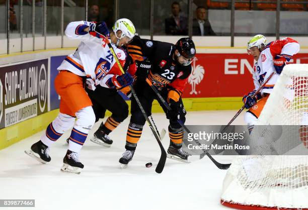 Gerrit Fauser of Wolfsburg and Aleksi Elorinne of Tampere battle for the puck during the Champions Hockey League match between Grizzlys Wolfsburg and...