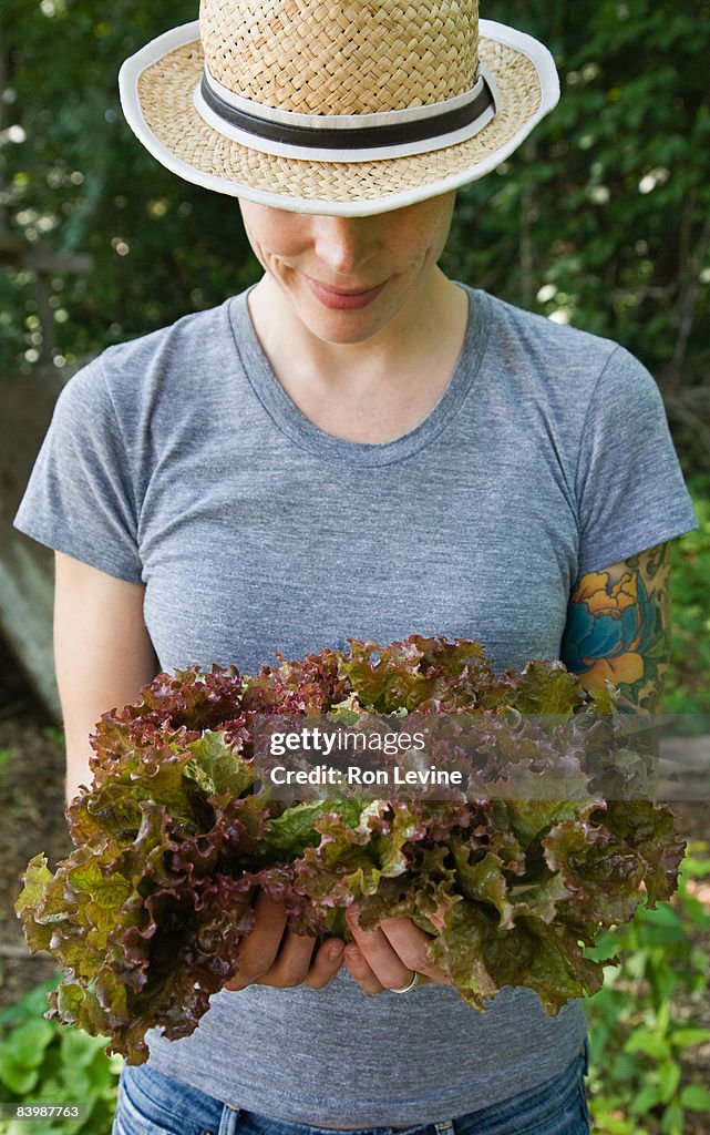 Farm worker with organic lettuce in hands