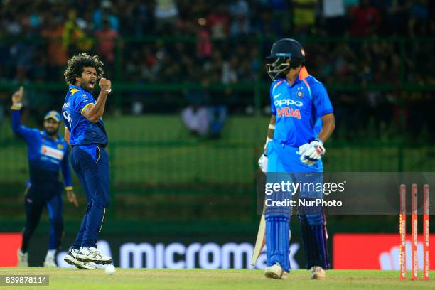 Sri Lanka's Lasith Malinga celebrates aftertaking the wicket of India's Shikhar Dhawan during the 3rd One Day International cricket match between Sri...