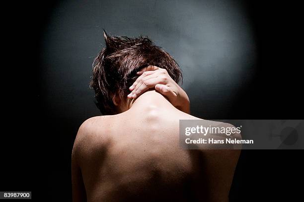 young nude woman holding her neck - fragile stockfoto's en -beelden