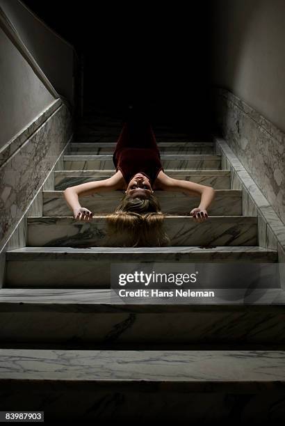 young woman lying on the stairs - ominous bildbanksfoton och bilder