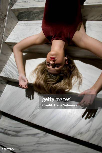 young woman lying on marble stairs - descending a staircase stock pictures, royalty-free photos & images