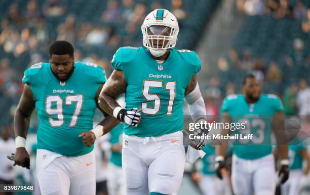 Mike Pouncey, Jordan Phillips, and Ndamukong Suh of the Miami Dolphins run off the field prior to the preseason game against the Philadelphia Eagles...