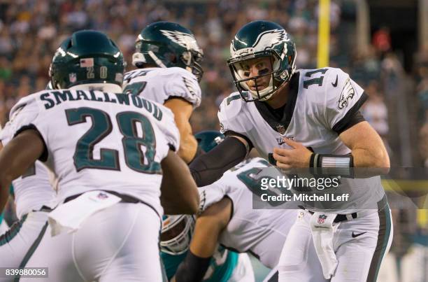 Carson Wentz of the Philadelphia Eagles hands the ball off to Wendell Smallwood in the preseason game at Lincoln Financial Field on August 24, 2017...