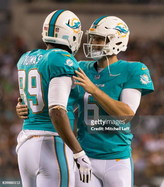 Julius Thomas and Jay Cutler of the Miami Dolphins react after a touchdown by Thomas in the second quarter against the Philadelphia Eagles in the...