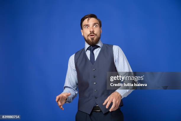 man looking terrified on blue background - fear face stock pictures, royalty-free photos & images