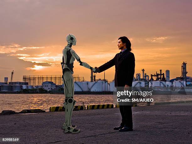 robot and man gretting at the port - robots stockfoto's en -beelden