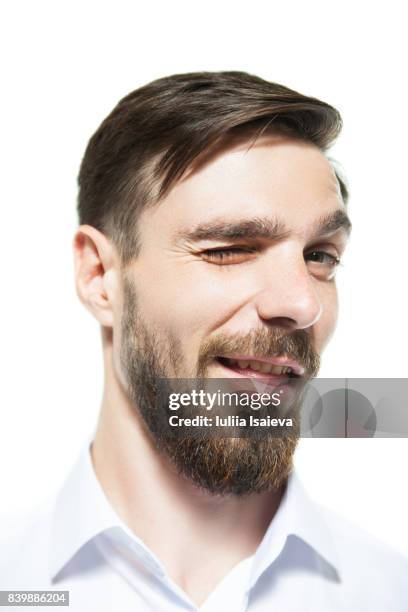 handsome man winking at camera - verführung stock-fotos und bilder