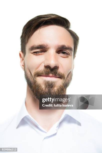 handsome man winking at camera - verführung stock-fotos und bilder