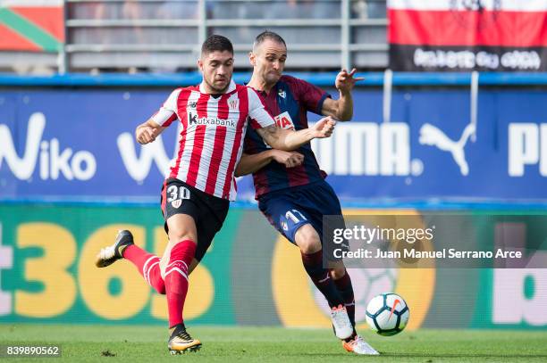 Kike Garcia of SD Eibar duels for the ball with Unai Nunez of Athletic Club during the La Liga match between Eibar and Athletic Club at Estadio...