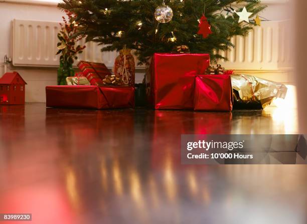 christmas presents under christmas tree - low section stockfoto's en -beelden