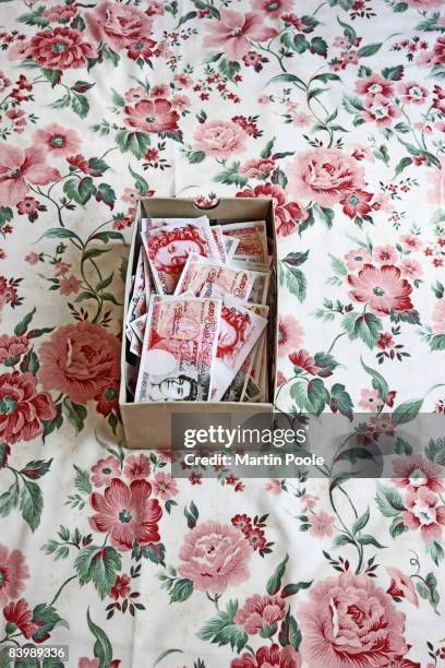 shoe box on bed full of £50 pound notes - shoe box stock pictures, royalty-free photos & images