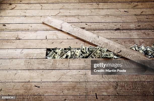 100 dollar bills stashed under a floorboards - nascondere foto e immagini stock