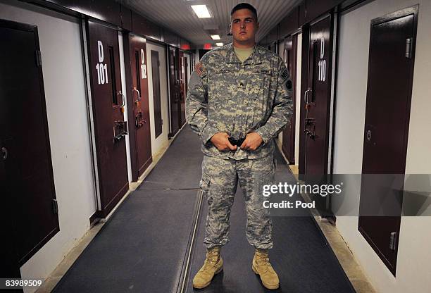 An image reviewed by the U.S. Military shows a guard in a hall outside cells in the Camp Five detention facility December 10, 2008 on U.S. Naval...