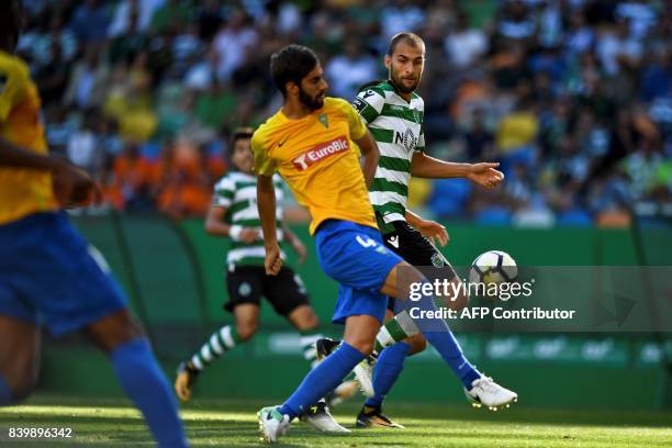 Sporting's Dutch forward Bas Dost vies with Estoril's defender Pedro Monteiro during the Portuguese league football match Sporting CP vs Estoril...