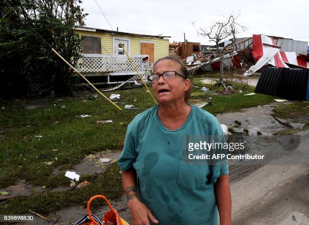 Local resident Kathy Neihaet walks through her damaged neighborhood after Hurricane Harvey hit Port Aransas, Texas on August 27, 2017 Hurricane...