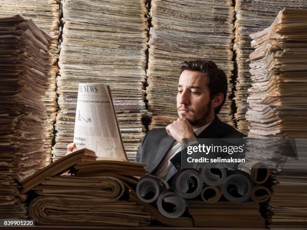 young man in formal wear doing research in printed media library - will files stock pictures, royalty-free photos & images