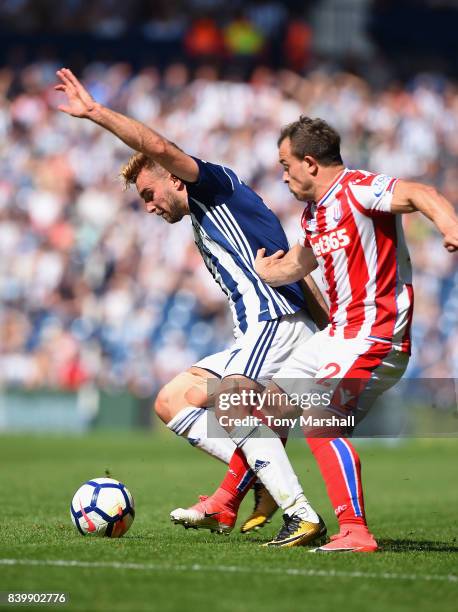 James Morrison of West Bromwich Albion is tackled by Xherdan Shaqiri of Stoke City during the Premier League match between West Bromwich Albion and...