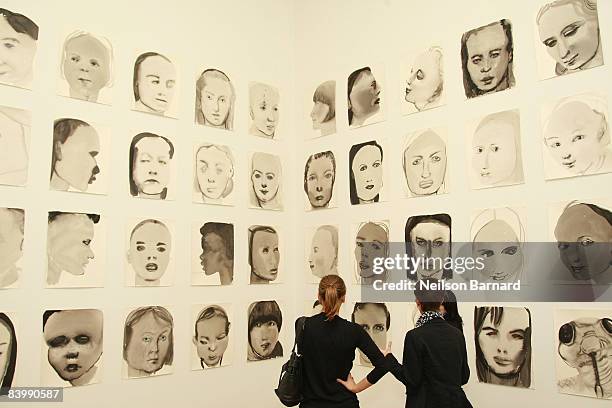 Guests view artwork by Marlene Dumas at the opening of two exhibitions, "Marlene Dumas: Measuring Your Own Grave" and "Artist's Choice: Vik Muniz,...