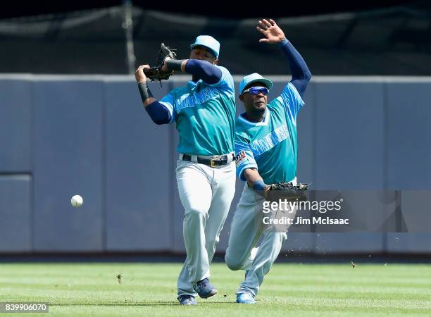Jean Segura and Guillermo Heredia of the Seattle Mariners can't come up with a ball hit by Gary Sanchez of the New York Yankees during the first...